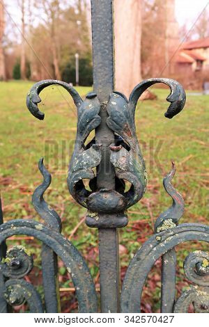Part Of An Iron Fence Gate With Metal Ornaments