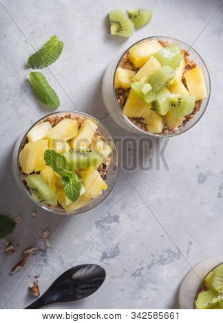 Parfait. Granola Parfait. Homemade Yogurt Parfait With Granola, Kiwi Fruit, Pineapple And Nuts In A 