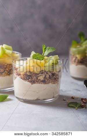 Parfait. Granola Parfait. Homemade Yogurt Parfait With Granola, Kiwi Fruit, Pineapple And Nuts In A 