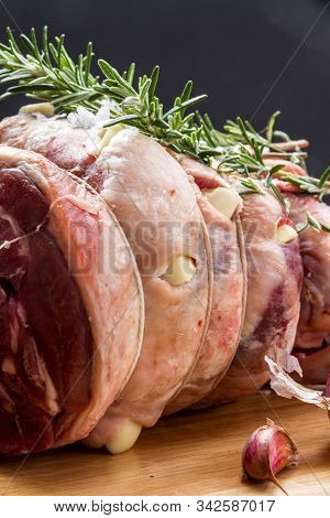 Raw Rolled And Tied Herdwick Sheep Lamb Joint Prepared With Garlic, Rosemary And Sea Salt.