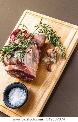 Raw Rolled And Tied Herdwick Sheep Lamb Joint Prepared With Garlic, Rosemary And Sea Salt.