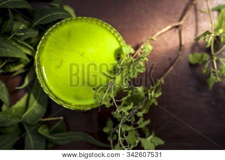 Close Up Shot Of Glass Bowl Full Of Tulsi Or Basil And Neem Or Indian Lilac Paste In It Along With F
