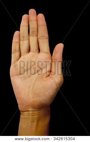 Isolated Pair Of Hands Of A Male Teenager On Black Background Doing Abhayaprada Yoga Mudra.vertical 