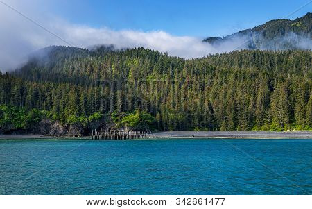 A Scenic View Along The Shoreline Of Kenai Fjords National Park In Alaska.