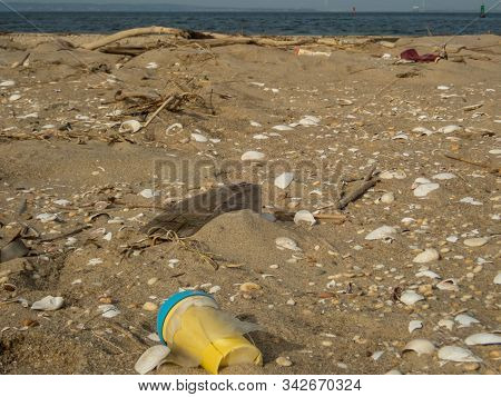 Plastic Debris Bottlecaps Styrofoam Garbage On Beach On A Sunny Winter Day At Sandy Hook, Nj