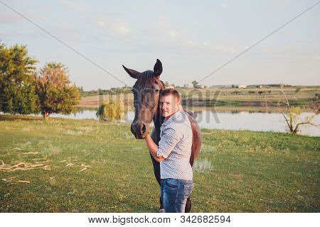 Young Man And A Horse In The Forest