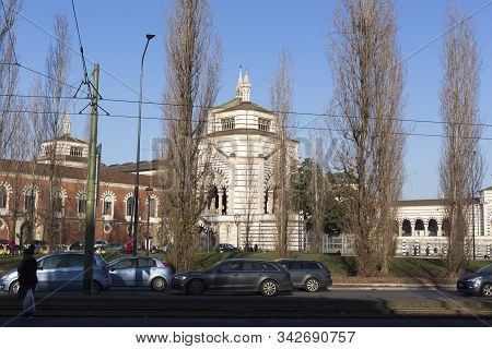Milan, Italy - January 01, 2020: Exterior Of Cimitero Monumentale Of Milano In Milan; Cars Passing B