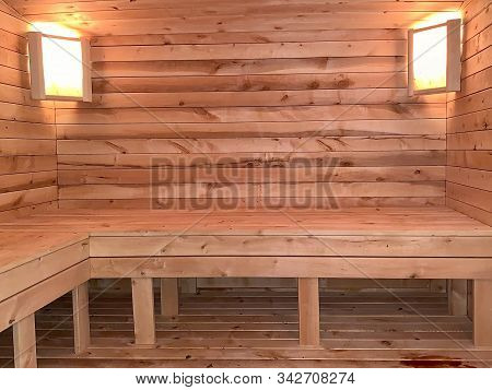 Wall Wooden Lining In The Steam Room. Lamps In The Finnish Sauna.