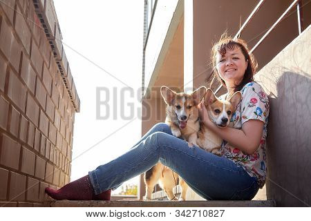Pretty Funny Girl With Small Nice Dog Big Wall Of City House In A Sunny Day