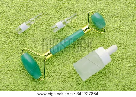 Jade Facial Roller And Face Serum In Ampoules And Bottle