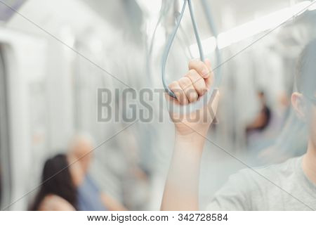 City Living Concept Male Hand Holding A Looped Handle In Urban Public Transportation