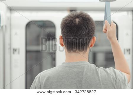 City Living Concept Male Hand Holding A Looped Handle In Urban Public Transportation