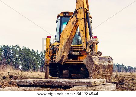 The Excavator Moves The Concrete Slabs To Set The Road In Private Territory.