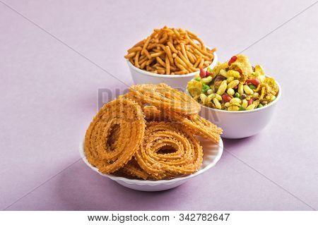 Indian Snack : Chakli, Chakali Or Murukku And Besan (gram Flour) Sev And Chivada Or Chiwada On Pink