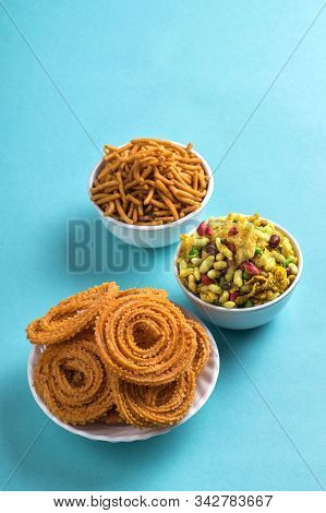 Indian Snack : Chakli, Chakali Or Murukku And Besan (gram Flour) Sev And Chivada Or Chiwada On Blue