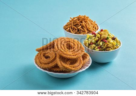 Indian Snack : Chakli, Chakali Or Murukku And Besan (gram Flour) Sev And Chivada Or Chiwada On Blue