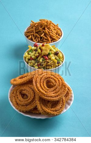 Indian Snack : Chakli, Chakali Or Murukku And Besan (gram Flour) Sev And Chivada Or Chiwada On Blue