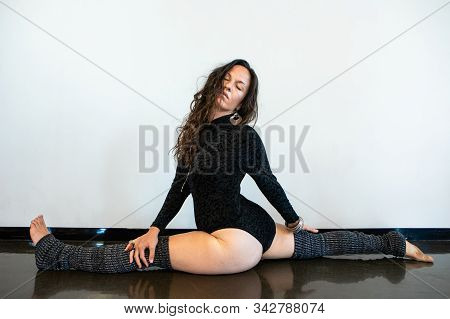A Slim Caucasian Woman Is Seen In A Wide Leg, Prasarita, Yoga Asana During A Vinyasa Flow Movement G