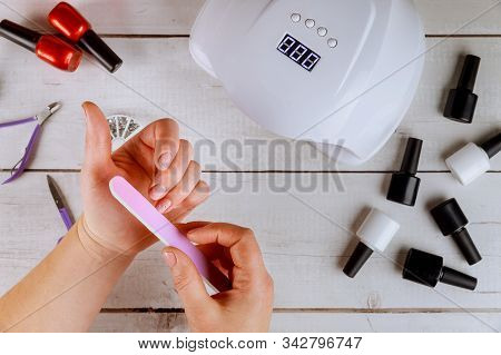 Woman Making Nail Manicure With Nail Board Or Nailfile.