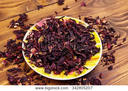 Dried Hibiscus (carcade, Roselle) On Wooden Table