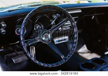 Close Up And Selective Focus On Antique Car Black Leather Steering Wheel, Simple Old Style Interior,