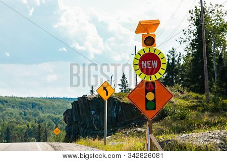Temporary Condition Road Warning Signs On The Roadside Before Road Work Zone, New Signal Traffic Lig