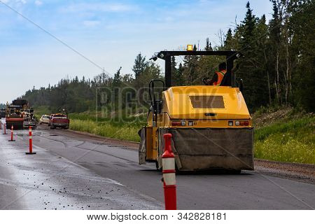A Heavy Duty Road Roller Is Seen Compacting Asphalt Subsurface During Roadworks On A Major Freeway, 