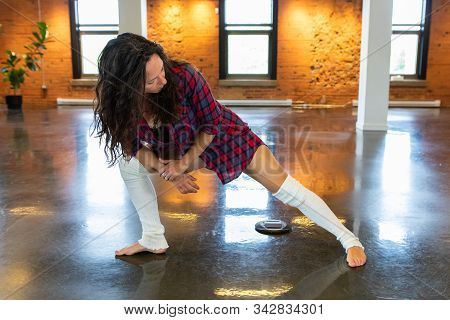 A Frontal Full Body View Of An Empowered Woman Performing Leg Warmup Stretches, Preparing For A Yoga