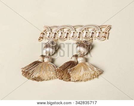 Cream-colored Decor Element For Decorating Curtains, Covers Or Upholstered Furniture. Tassels, Glome
