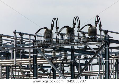 High Voltage Electrical Substation Tower Top, Close Up On A Closed Electrical Isolator Or Electrical