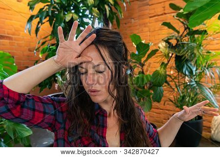 Beautiful Caucasian Girl In Her Thirties With One Hand Raised To Forehead As She Practices Deep Brea