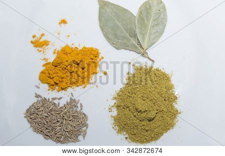 Seasonings On A White Leaf In Bulk: Turmeric, Cumin, Hops Suneli, Bay Leaf
