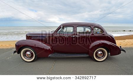 Felixstowe, Suffolk, England - May 05, 2019: Classic Dark Red Studebaker  Motor Car Parked  On Seafr