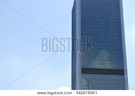 Geometric Reflection: Partly Cloudy Sky Reflected By Window Panes Of Office Building. Surface Of Gla
