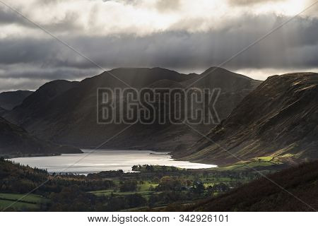 Epic Sun Beams Light Up Crummock Water In Dramatic Autumn Fall Landscape Image With Mellbreak And Gr