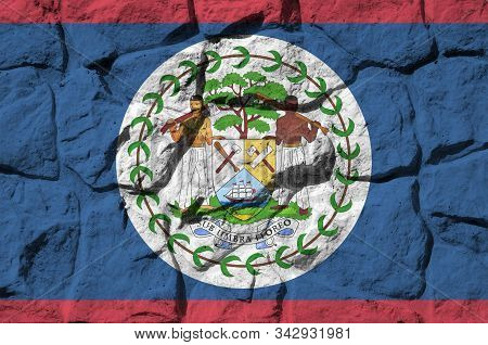 Belize Flag Depicted In Paint Colors On Old Stone Wall Closeup. Textured Banner On Rock Wall Backgro