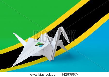 Tanzania Flag Depicted On Paper Origami Crane Wing. Handmade Arts Concept