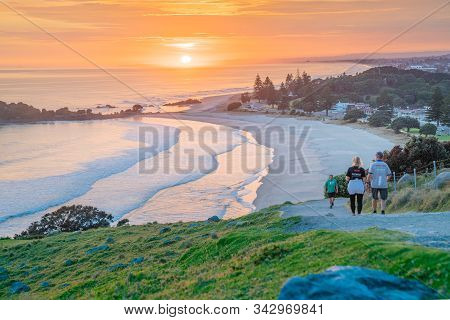 Mount Maunganui New Zealand - December 14 2019; Early Morning Walkers At Sunrise On Track On Slopes 