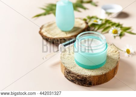 Daily Hygiene And Female Healthy Skincare. Cosmetic Cream And Face Serum With Cammomile Flofers On A