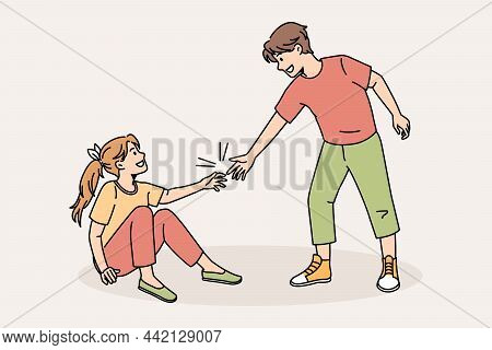 Caring Boy Give Hand Help Friend Rise Up After Falling. Kind Small Child Show Care For Girl Mate. Go