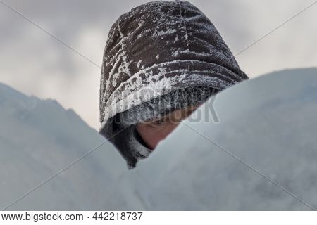 A Portrait Of A Fitter With A Hood On His Head