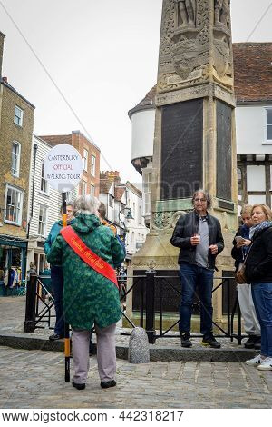 Canterbury, Kent, England - Oct 23 2021: Canterbury Official Walking Tour Guide Talks To Group Of To