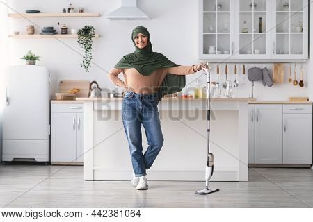 Smiling Muslim Woman Cleaning Floor With Spray Mop, Posing