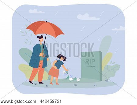 Mother And Daughter Standing At Headstone Under Umbrella In Rain. Little Girl Putting Flowers On Gra