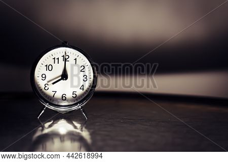 Retro Clock Showing 8h Or 8 O' Clock In Noir Styled Vintage Setting. Close-up And Detail