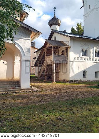 High Wooden Porch With Carved Elements In The Old Russian Style. Entrance To The White-stone Russian