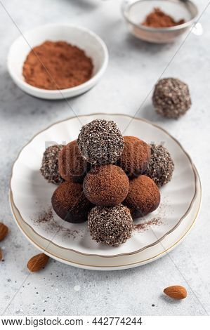 Raw Energy Balls With Chia Seeds, Cocoa Powder And Almonds On Gray Background. Vegan Alternative Foo