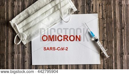 Word Omicron On Notepad With Mask And Corona Virus Vaccine. Omicron Is A New Type Of Corona Virus Fr