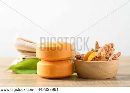 Turmeric Soap And Fresh Turmeric Root In A Bowl On Wooden Table With White Background, Herbal Organi