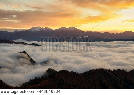 Mountains In Fog At Sunset In Autumn. Landscape With Alpine Mountain Valley. Aerial View